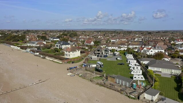 East Preston seafront village in West Sussex with the Camping site in view next to a cafe. Aerial 
