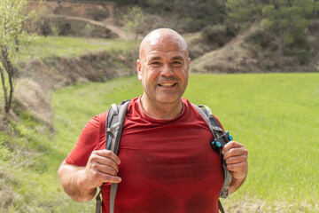 Sweaty hiker man looking at camera with smiling face