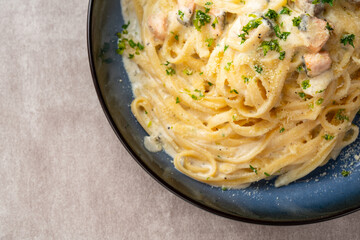 homemade fettuccine pasta with white cream sauce. fettuccine Carbonara made with eggs, hard cheese, cured pork, and black pepper. Italian food.