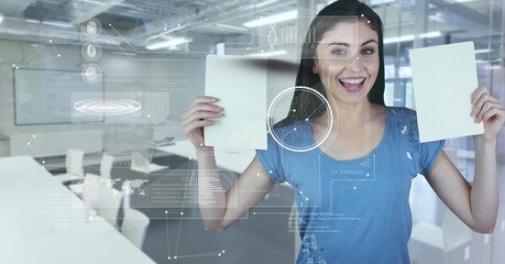 Digital interface with data processing against caucasian woman holding blank papers at office