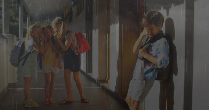Composite video of rainfall and thunderstorms against group of students bullying a boy at school