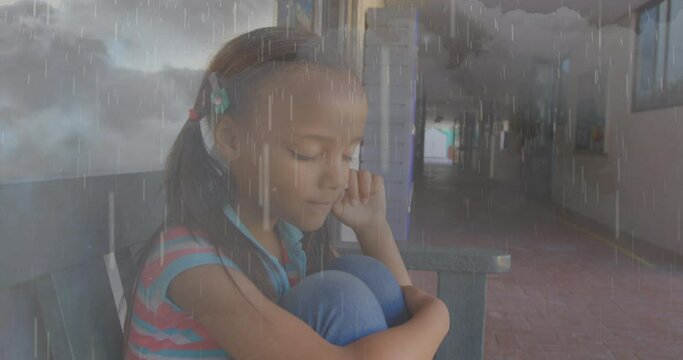 Composite video of rainfall and thunderstorms against stressed african american girl at school