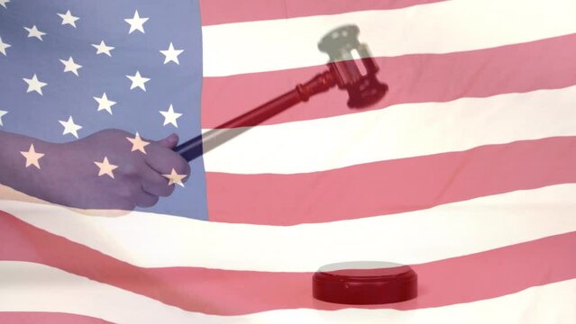 Composite video of waving american flag against hand banging a gavel