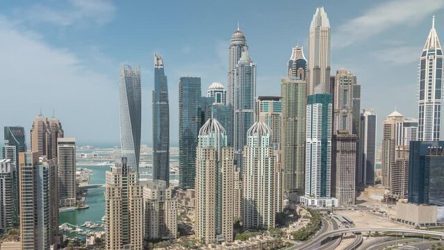 Skyscrapers of Dubai Marina near intersection on Sheikh Zayed Road with highest residential buildings all day timelapse