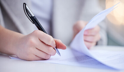 The paperworks piled up. Shot of an unrecognizable businessperson going through paperwork at work.