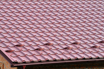 The roof of the house is covered with metal tiles