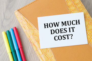 How Much Does it Cost. Business concept. Text on white notepad paper on light background