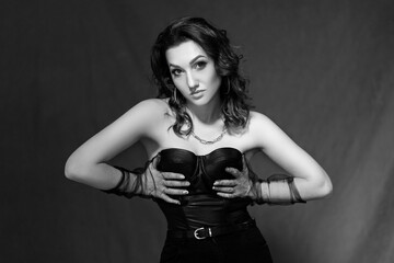 Fototapeta na wymiar black and white portrait. Sexy girl in a black corset and gloves