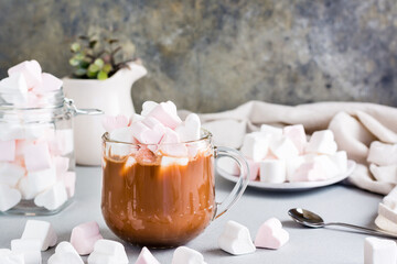 Sweet cocoa with heart-shaped marshmallows in a cup on the table