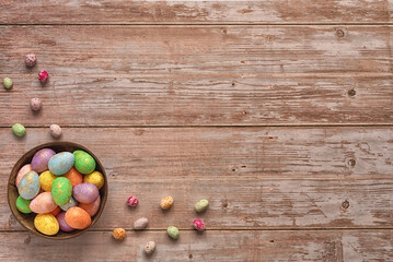 Colorful Easter eggs on a wooden table. Copy space. Top view. Easter holiday concept.  Easter composition, postcard.  Horizontal photo.