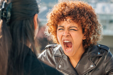 women arguing and yelling in the street