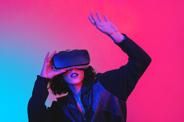 The young woman is using virtual reality viewer. Modern woman portrait with trendy look and bright colors. - 498137550