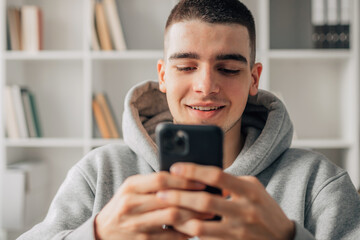 young teenager looking at mobile phone