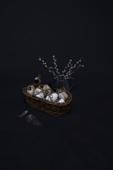 basket with eggs in the studio on a black background