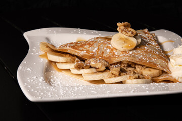 Banana Crepe with Carmel and nuts with side of whip cream 