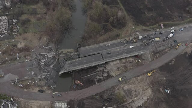 Post-apocalypse. Destroyed bridge with burnt cars. War. Ukraine. Irpin. Aerial 