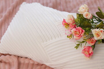 Pink roses on pillow, flowers on bed, lifestyle romantic staging