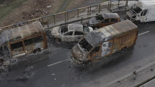 Post-apocalypse. Destroyed bridge with burnt cars. War. Ukraine. Irpin. Aerial 