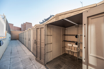 Prefabricated resin storage rooms in a corridor of an urban plot