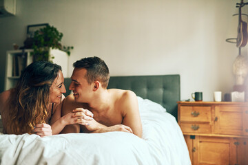 You cant fake that chemistry. Shot of an affectionate young couple spending a romantic morning in bed at home.