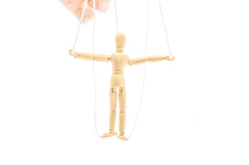 A wooden figure of a man on ropes. Isolated on white.The social concept