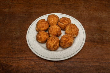 Delicious round croquettes of fresh cheese and ham tacos on a circular plate