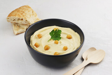 Hummus traditional oriental vegan sauce from chickpea and pieces of bread. Healthy food