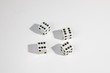White dice with a six standing close to each other on a white background. Win or lose. Catch your luck. Gambling equipment.