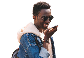 Portrait of happy smiling young african man holding smartphone using voice command recorder,...