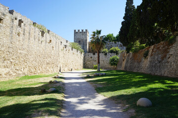 Fototapeta na wymiar Path between the walls of the citadel of medieval city Rhodes. Principal city on the island of Rhodes in the Dodecanese, Greece