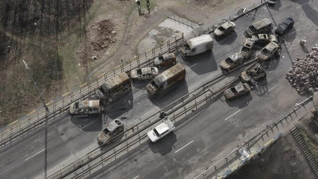 Post-apocalypse. Destroyed bridge with burnt cars. War. Ukraine. Irpin. Aerial 