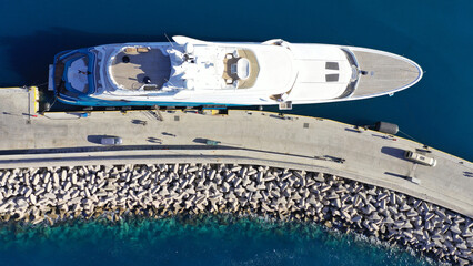Aerial drone top view photo of luxury yacht anchored in mediterranean port
