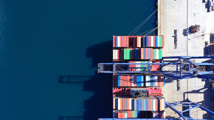 Aerial drone top down photo of container tanker anchored in loading - unloading container terminal...