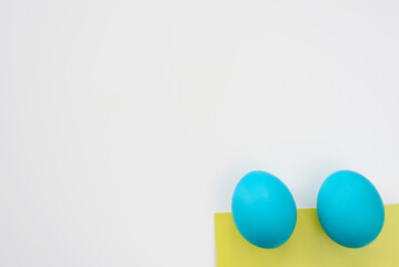 Top view of blue easter eggs lying on white table. Copy space. Easter concept.