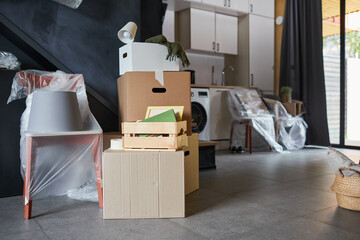 Close up background image of messy cardboard boxes filled with decor in new home, family moving and relocation concept, copy