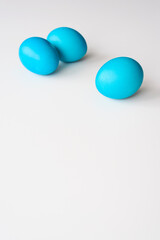Easter eggs, lying on a white background, with copy space. Painted blue. Easter concept.