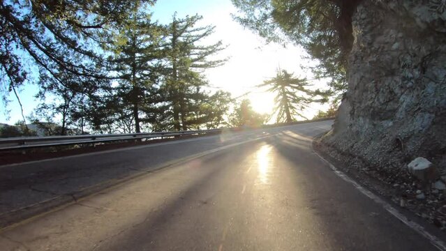Sunrise driving curve Mt Wilson Road in the San Gabriel Mountains in Los Angeles County, California.