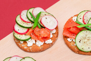 Crispy Cracker Sandwiches with Fresh Salmon, Cucumber, Radish, Cottage Cheese and Green Onions. Easy Breakfast. Quick and Healthy Sandwiches. Crispbread with Tasty Filling. Healthy Dietary Snack