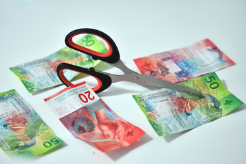 scissors with banknote from zwitserland swiss