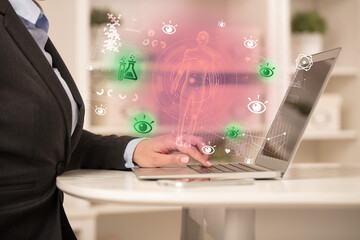 Doctor working on laptop with healthcare concept