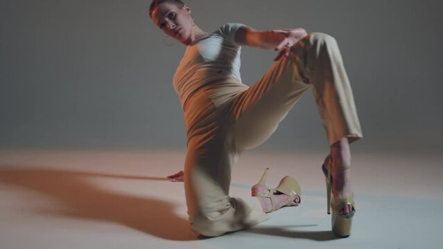 Alluring young sexy girl dancing on studio floor, performing contemporary vogue femme dance. ProRes codec