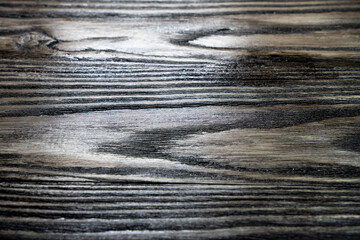 Rough natural wooden backdrop. Grunge background. Texture of freshly cut wooden planks arranged in lines. Rustic dark weathered wooden texture. Top view. Copyspace. Vintage style.