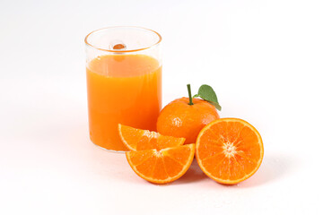 oranges, halved oranges, healthy fruit, mandarin oranges, orange juice in glass, vitamin C, against a white background with refreshing drops of water