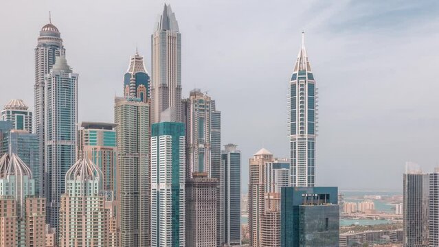 Skyscrapers of Dubai Marina near intersection on Sheikh Zayed Road with highest residential buildings all day timelapse