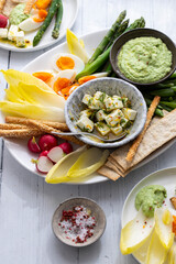 Easter sharing platter with eggs, asparagus, crunchy vegetables and feta