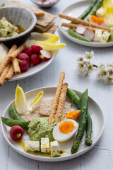 Easter sharing platter with eggs, asparagus, crunchy vegetables and feta
