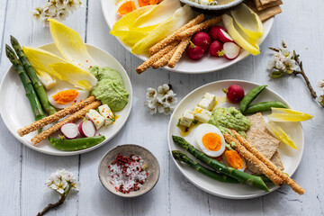 Easter sharing platter with eggs, asparagus, crunchy vegetables and feta