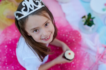 Every little girl should feel like a princess. Portrait of a little girl dressed up as a princess having a picnic outside. © Adene Sanchez/peopleimages.com