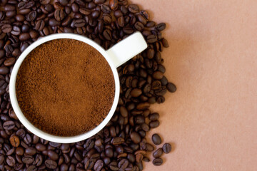 Fresh coffee in the cup and on the ground. Suitable for background and texture
