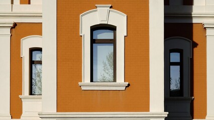 classy arched windows in brick facade